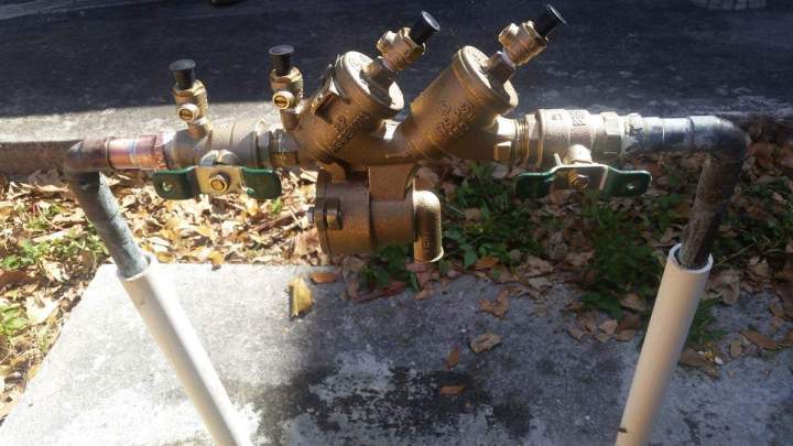 Plumber fixing a dripping faucet Homestead