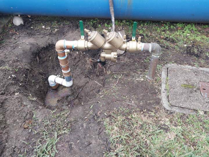 Plumber fixing a dripping faucet Homestead